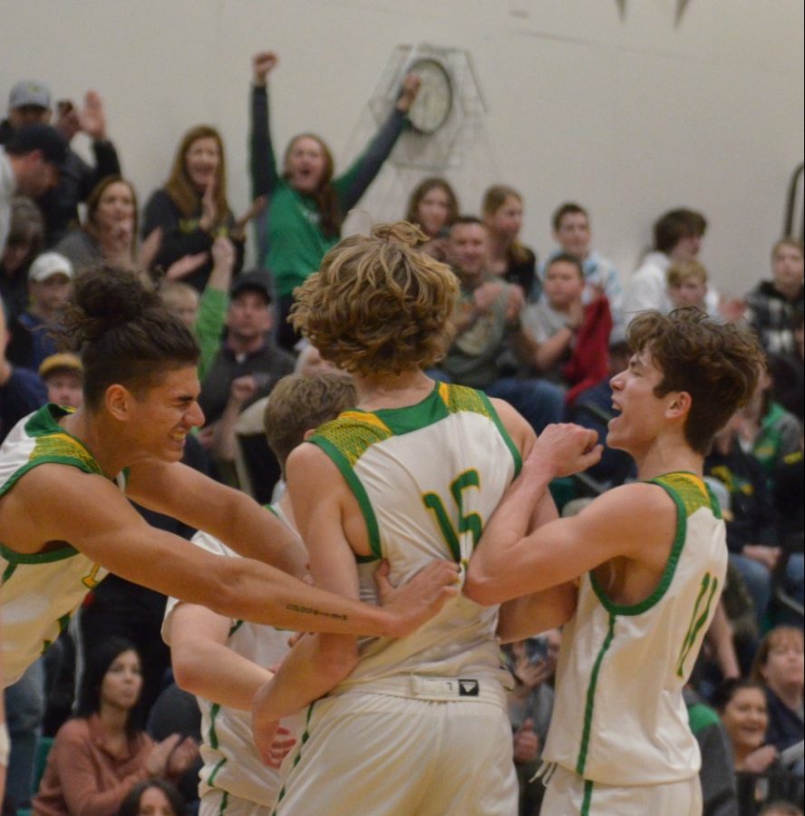 Jalen Skalskiy and Bryce Henry running up to Noah Haaland after Haaland laid the ball up and got an and one. 
