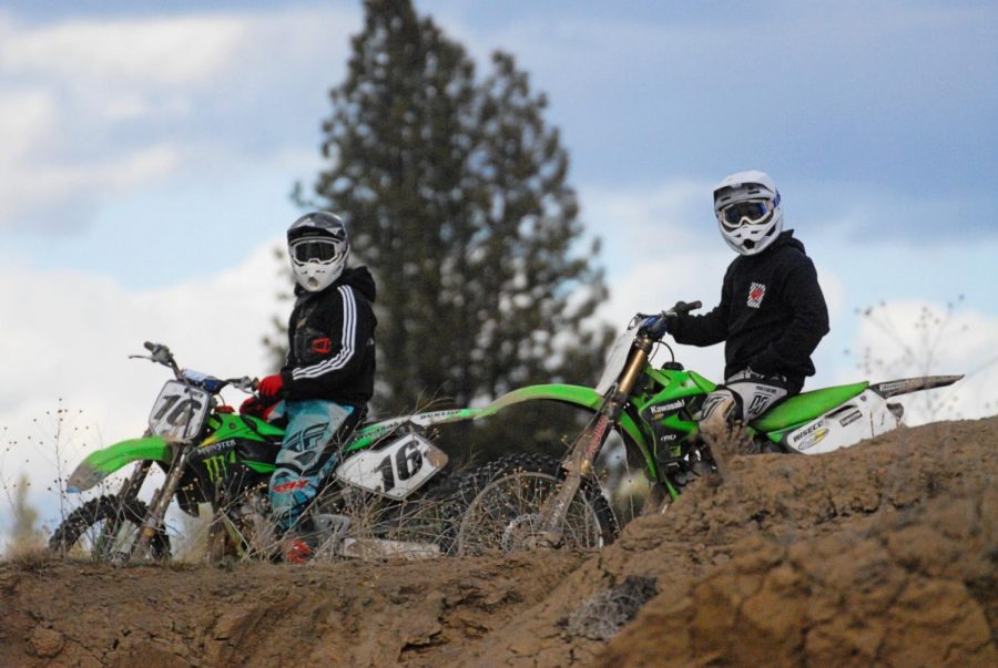 Dirt bike riders pose with their bikes on top of a hill at the Riverside State Park ORV park in 7 Mile, Washington 