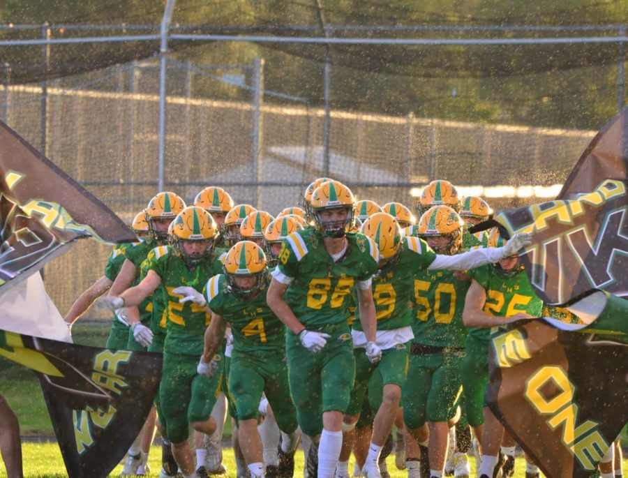 #88 Alden Waddington leads the Lakeland Hawks Varsity Football Team out to the field on August 27th at Lakeland High School. 
