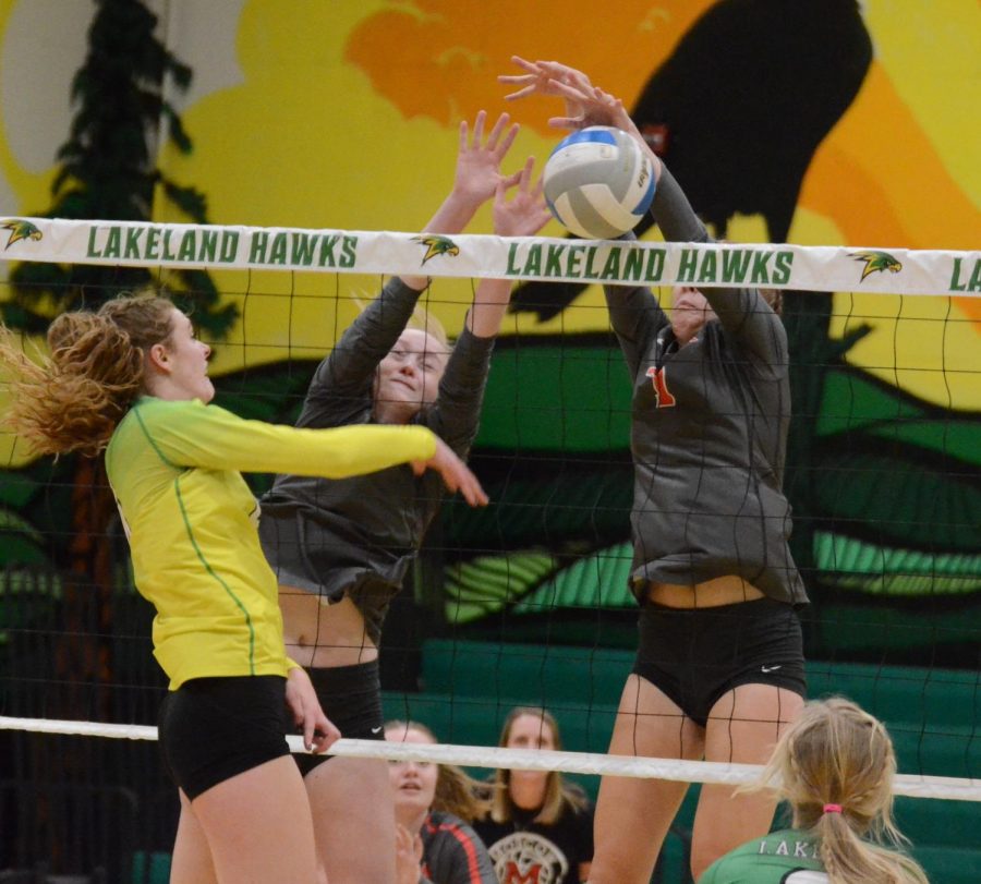Bethany Johnson spike being blocked by two Moscow Players