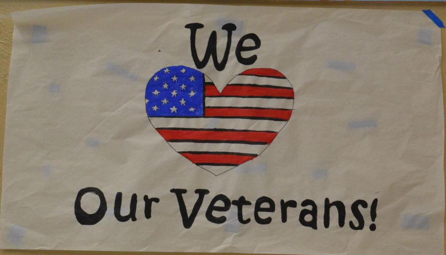 A+poster+thanking+veterans+hangs+in+the+school+hallway.