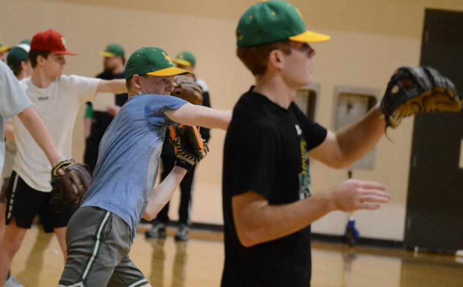 Baseball+players+passing+back+and+forth+at+the+beginning+of+tryouts.