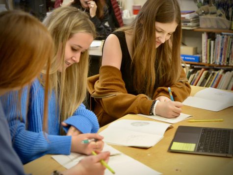 A group of students work on art together.