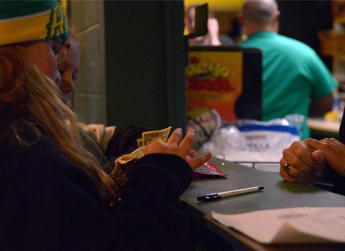 Mini Hawks pay for their candies at the Lakeland Hawk Concession stand.