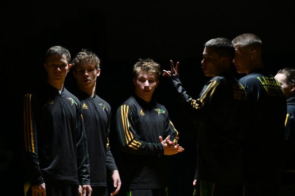 The team talks before wrestling. 