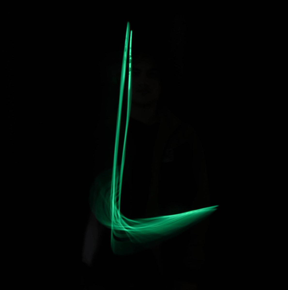 Levi Parongao uses a glow stick to write the first L in Lakeland.