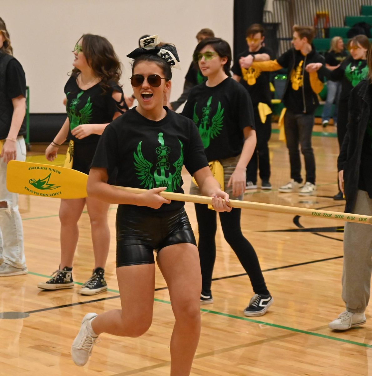 Shelby Wear runs down the court with the paddle in the lip sync. 