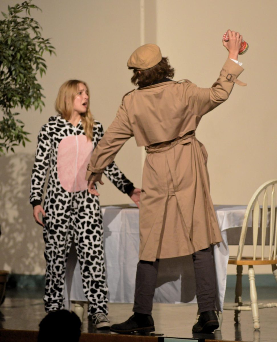 Derrick Clement brandishes a knife at Leann Lohf during their murder mystery play