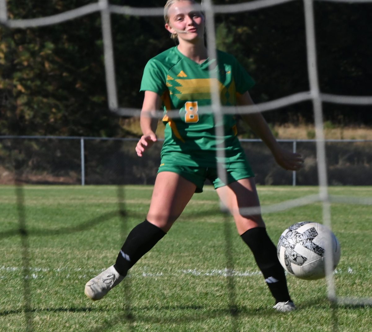 Natalie Rose kickes ball into goal