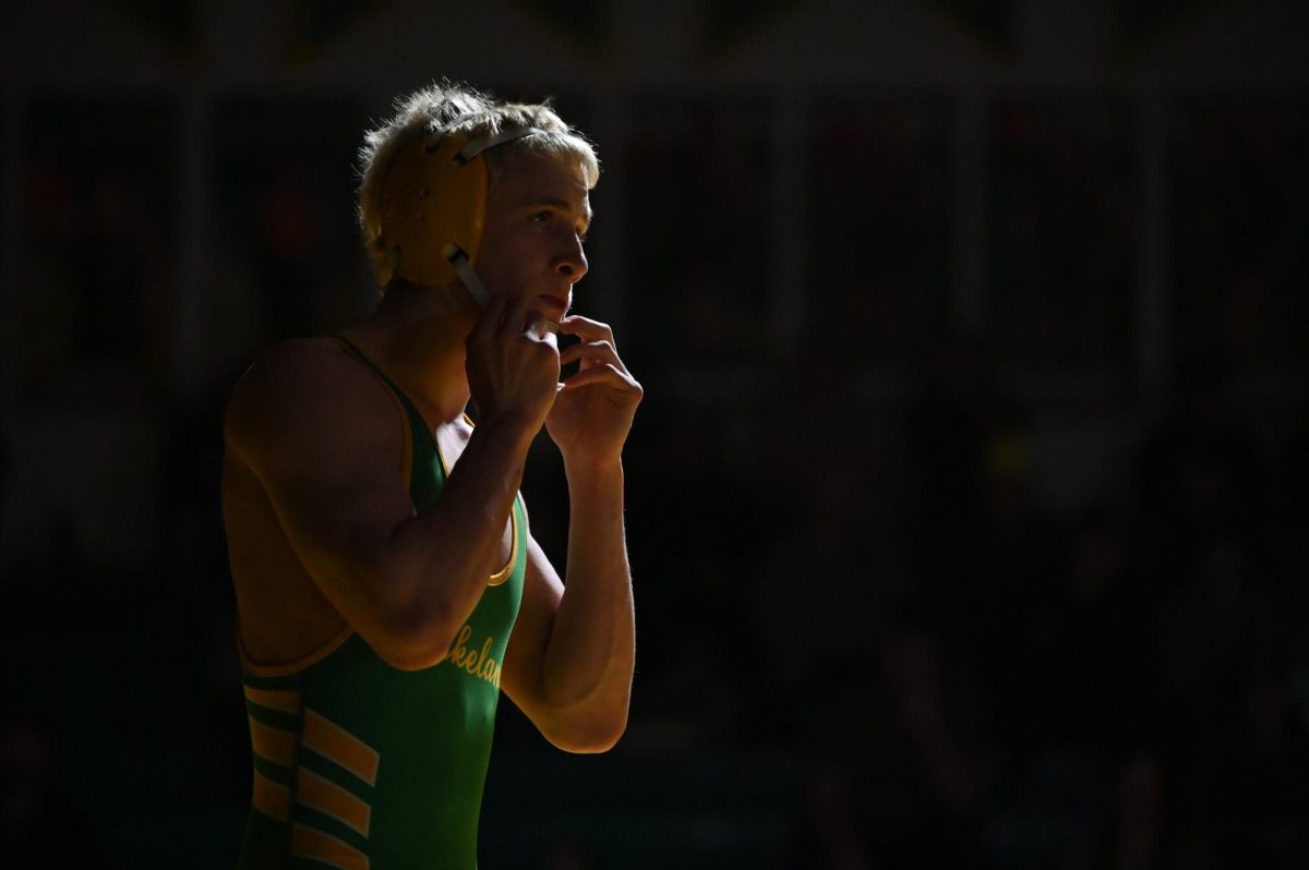 Justin Baxter adjusts his chin strap during blood-time