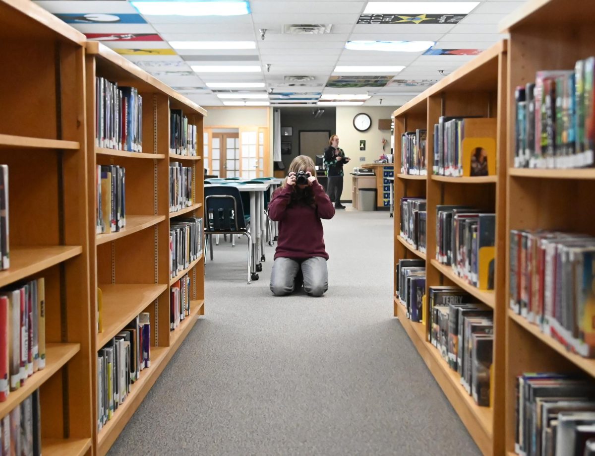 Sofia Holan takes a photo in the library. 