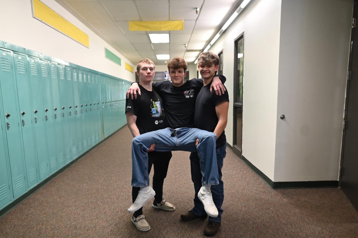 Austin Howell and Chase Peterson holds Zach Mcgee.