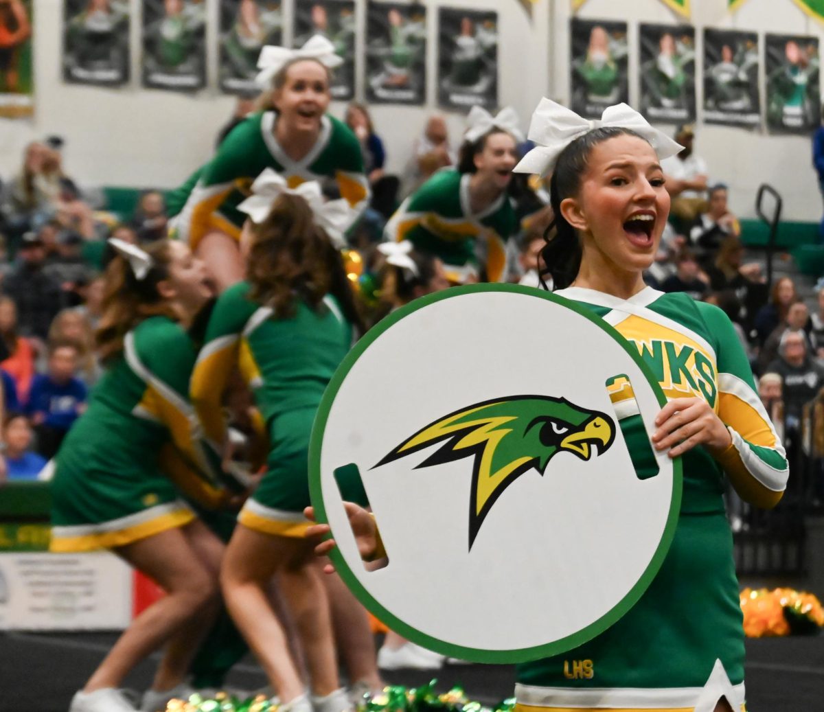 Kyra Lundt shouts a cheer during the sideline routine. 