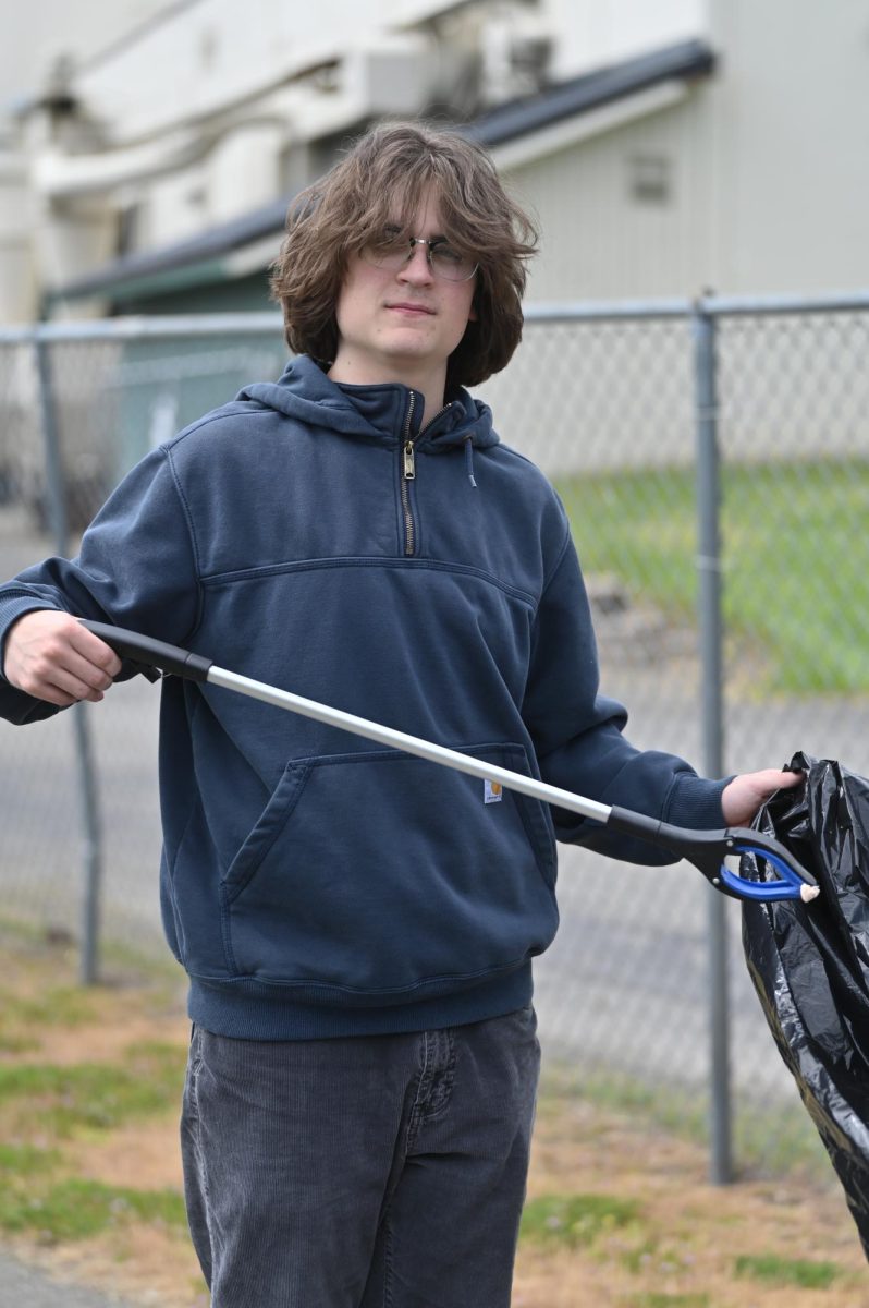 Daniel Killian picks up a piece of gum off the ground.