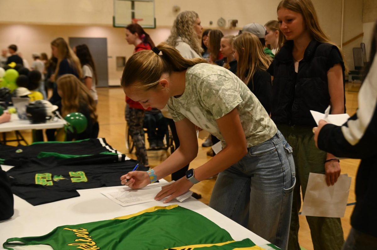 Up coming freshman signs up for track.