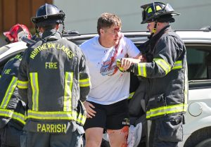 Carter Vanek is helped out of the car. 