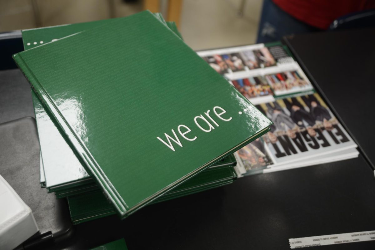 A yearbook sits on a pile.