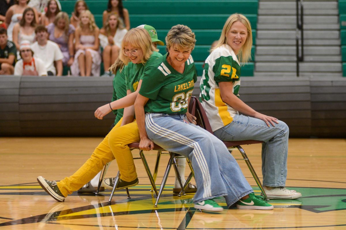 Mrs. Novak watches as Mrs. Letzig and
Ms. Gorton fight over a seat during musical chairs.