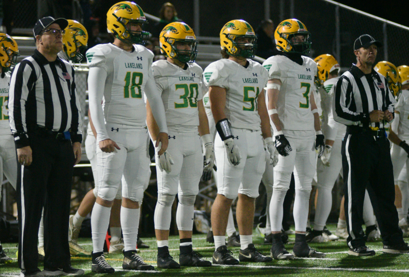 Team captains Peyton Hillman, Peyton Sardinha, Will Peed, and Jace Taylor line up before coin toss