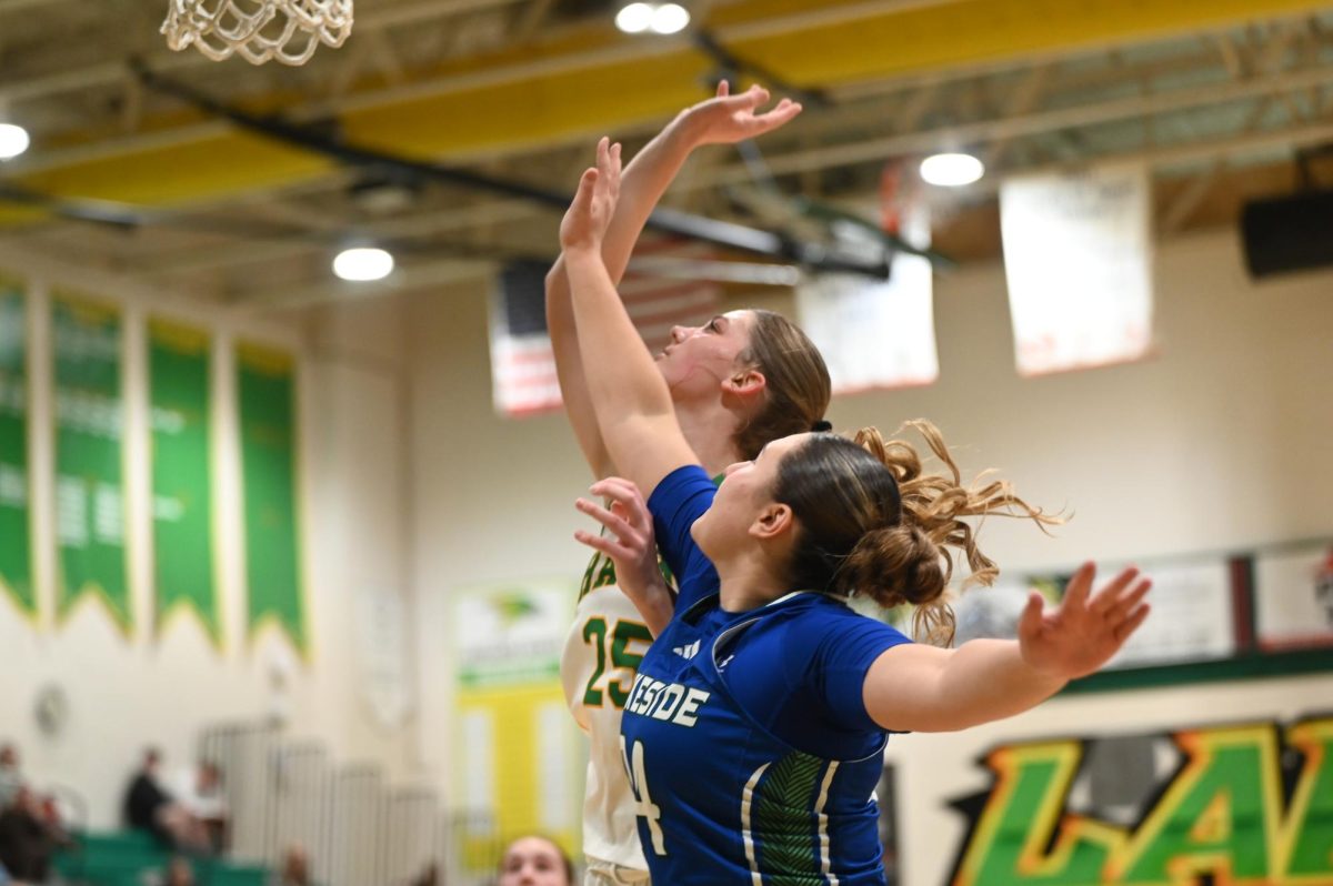 Macy Bretveld jumps for the rebound. 