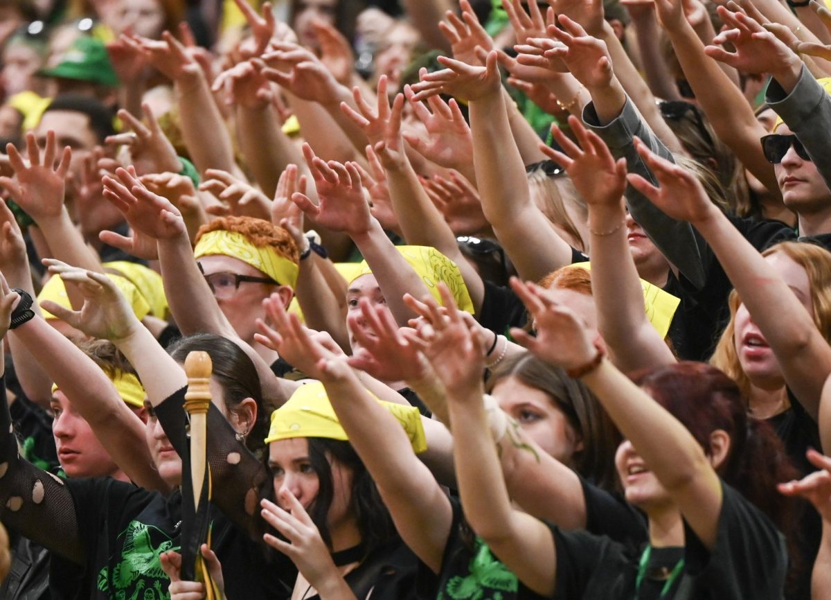 Students show their spirit during a free throw. 
