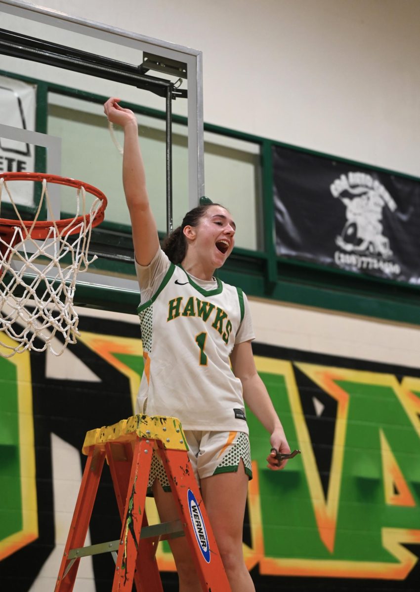 Karstyn Keifer hold the net after the Hawks win after the Hawks district championship game vs. Sandpoint on Feb.10 