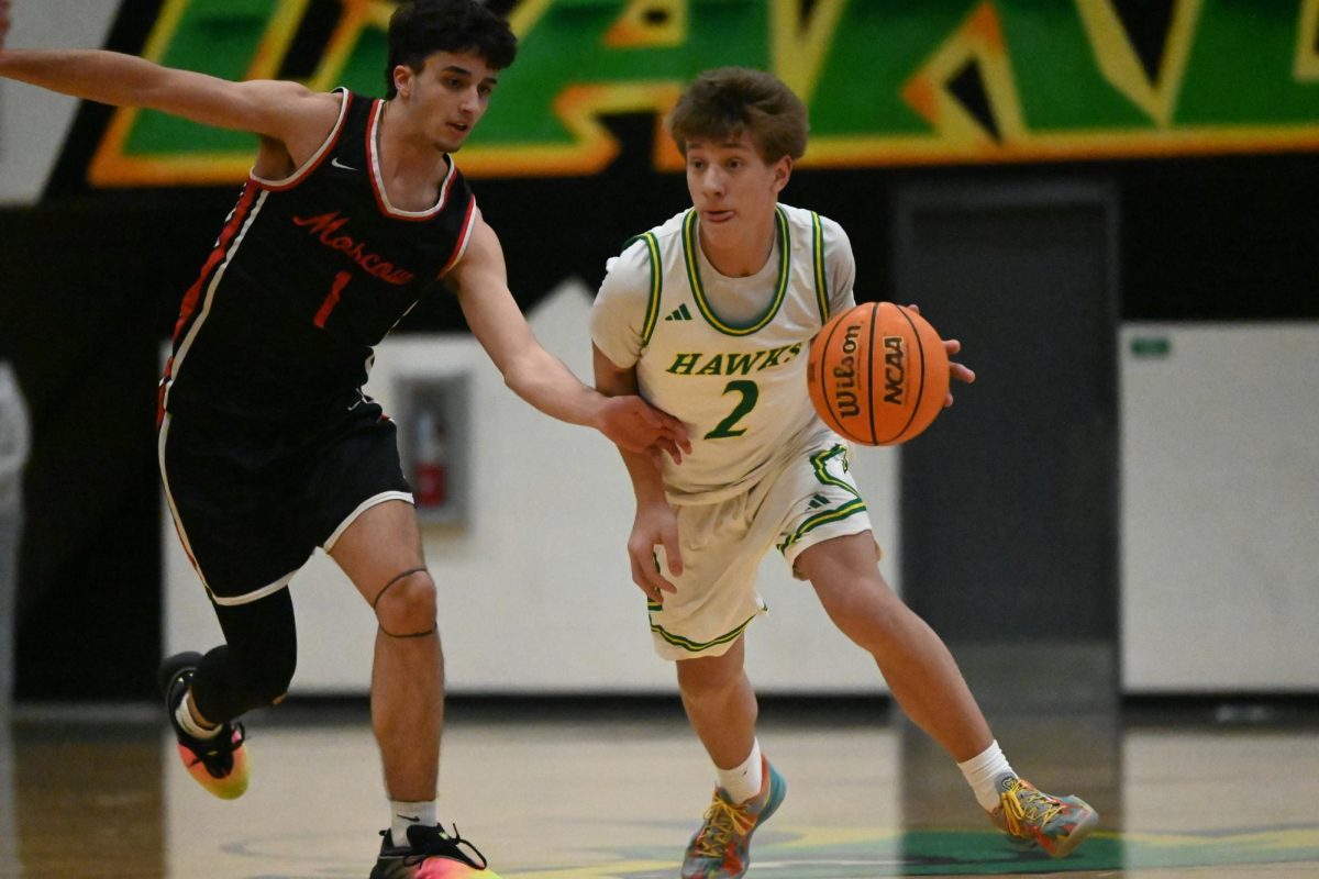 Trent Boardman dribbling the ball down the court