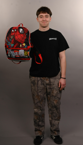 Kayleb Pittman holds his Spiderman backpack